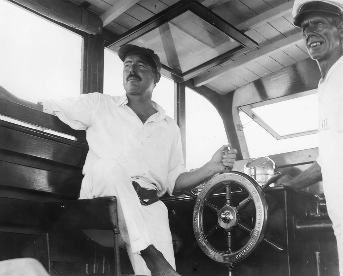 #3 Ernest Hemingway and friend Carlos Gutierrez partying Hemingway’s fishing boat, the Pilar, in 1934