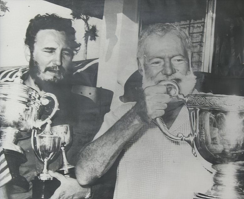 #6 Hemingway and Fidel Castro partying at a fishing tournament in 1960. Castro won the trophy for the largest marlin