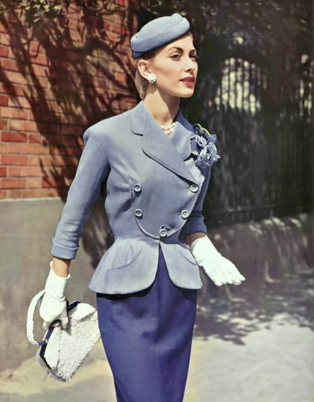 #9 Geneviève Richard in a summer suit of lilac and purple linen, the curved jacket has a bib front by Pierre Balmain, 1954.