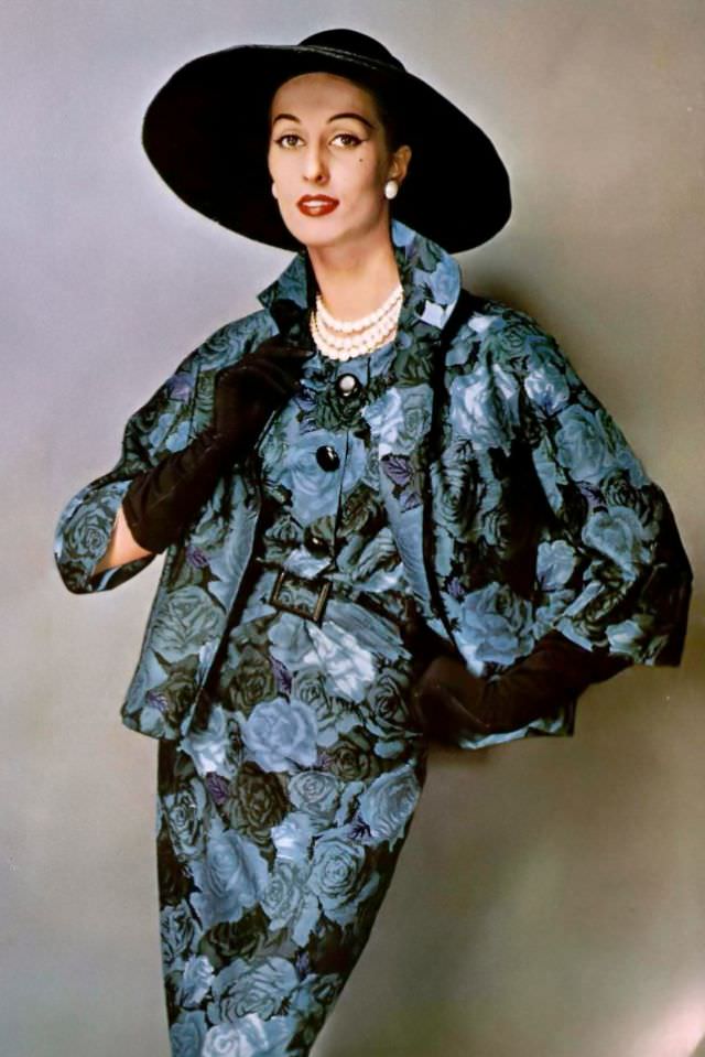 #21 Marina Nicolaïdes in a crepe sheath dress and short jacket in a blue and green rose print by Pierre Balmain, 1957.