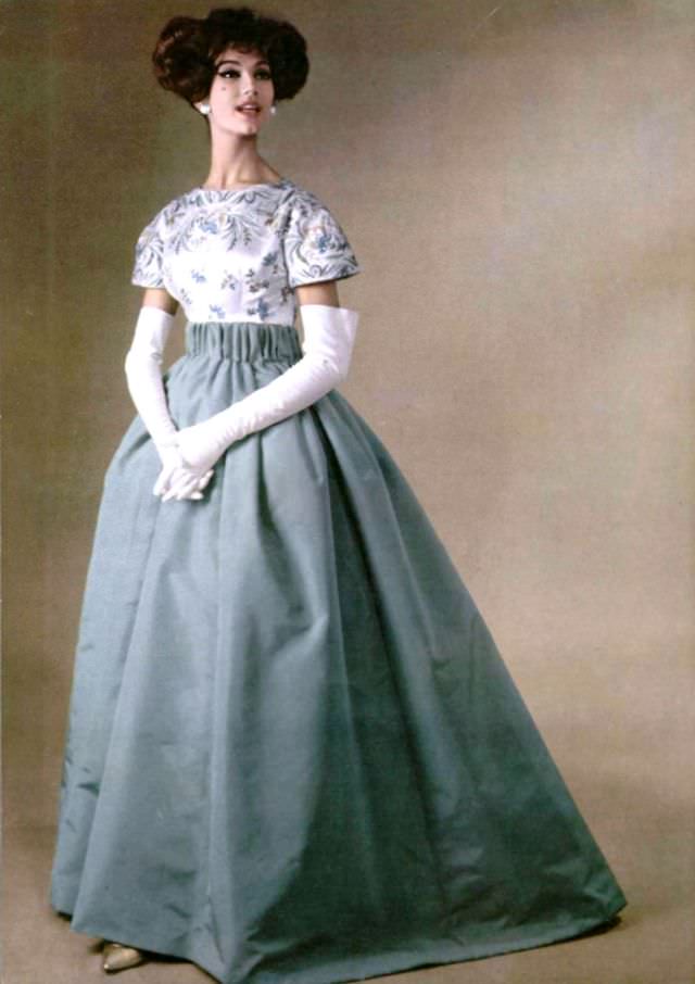 #33 Simone d’Aillencourt in a gala evening gown of silk faille skirt with an embroidered satin top, by Pierre Balmain, 1958.