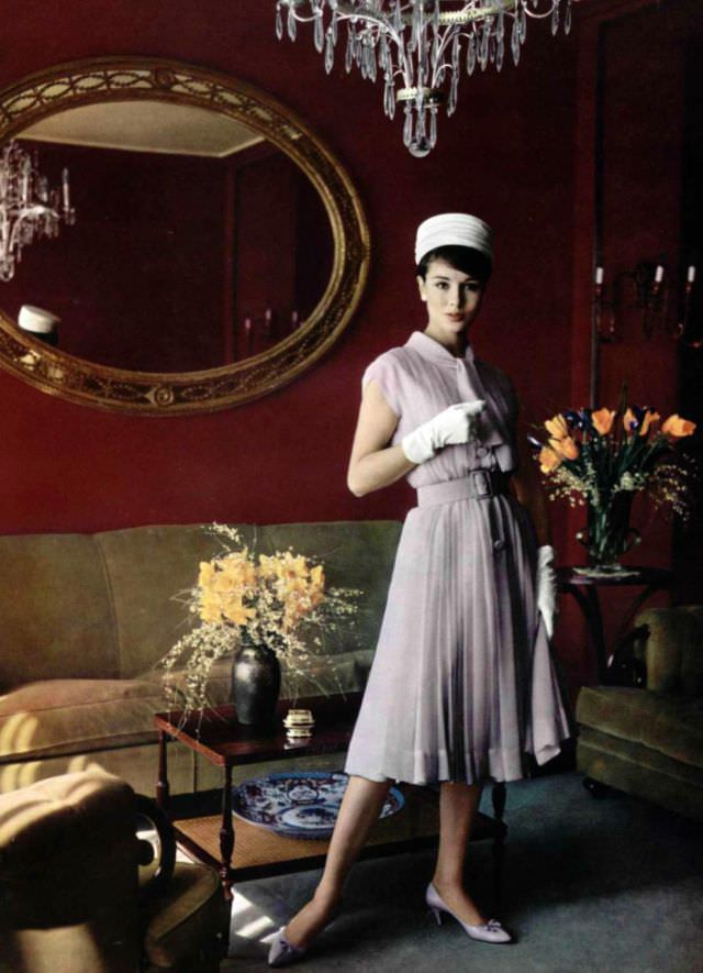 #40 Sondra Peterson in a pale lilac silk mousseline dress, belted and pleated by Pierre Balmain, 1959.