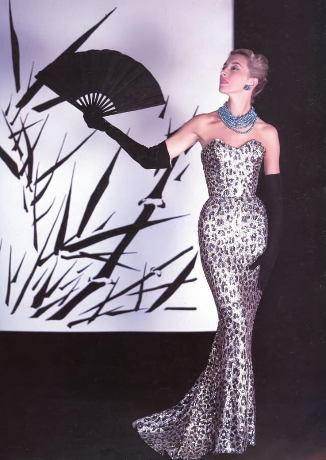 #6 Marie-Thérèse in Balmain’s famous sheath of embroidered paillettes in a leopard spot design, 1953.