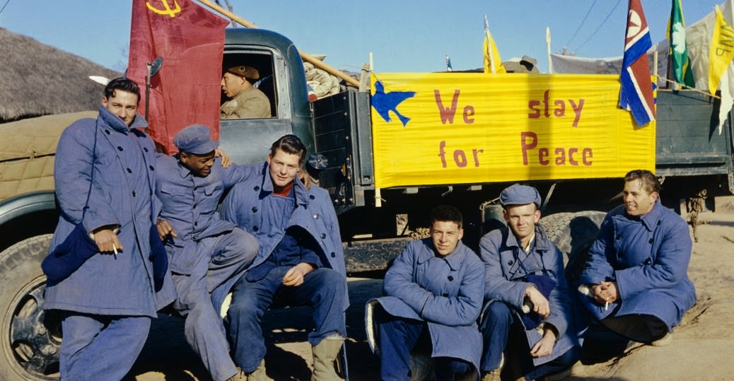 Twenty-one American soldiers refused to return to America at the end of the Korean War. The sign on the truck reads: “We Stay for Peace.” They moved to China; by the 1960s, all but two had returned home.