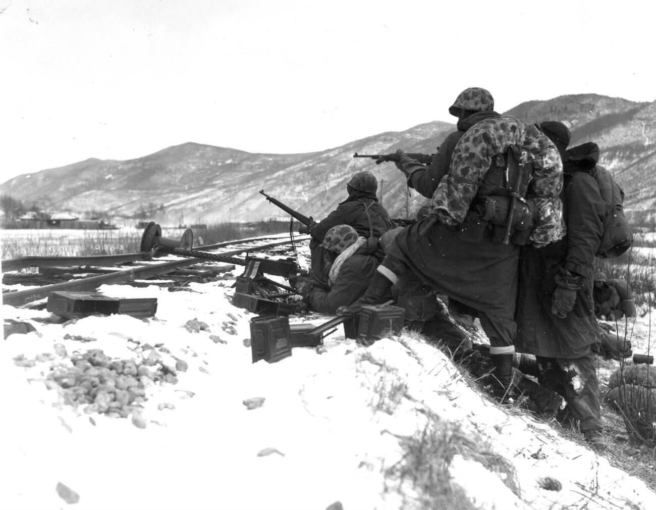 First Division Leathernecks counter fire when attacked by well-entrenched Chinese Communist troops during the Division’s heroic breakout from Chosin, 1950s.