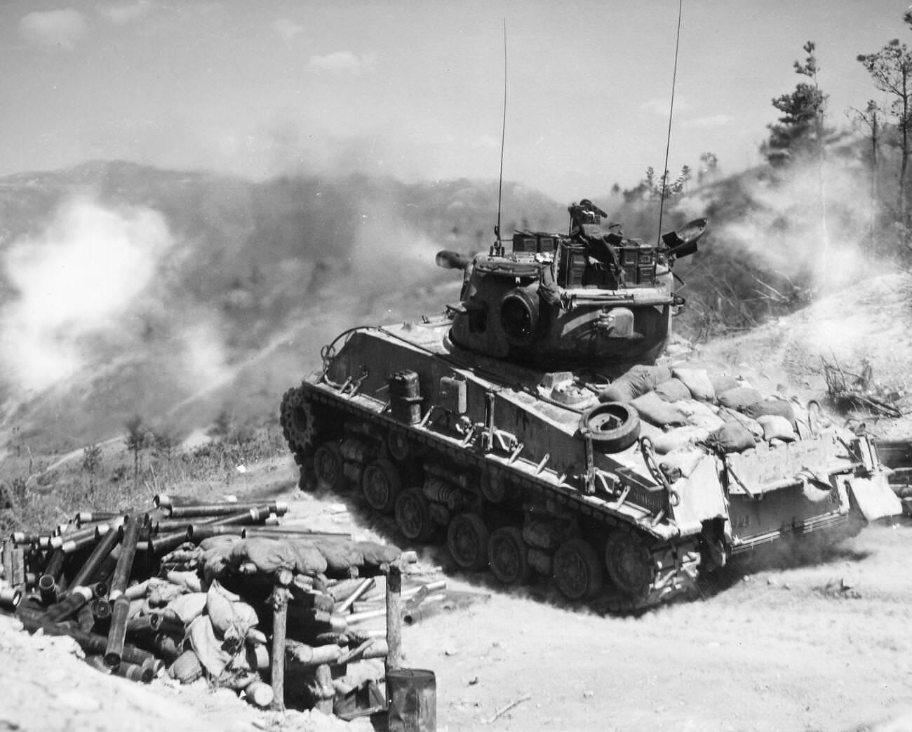 #14 A tank of the 2nd Infantry Division fires on Communist bunkers on the Korean front, 1952.