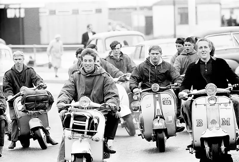 #4 Mods on scooters ride down the streets of Hastings, England, 1964.