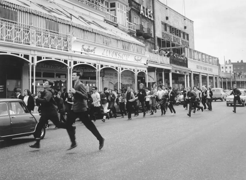 #8 Mods flee the scene after a brawl with rockers in Margate, England, 1964.