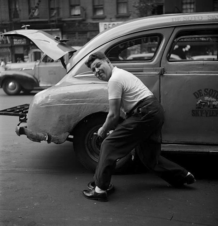 #24 Changing a tire, 1946.