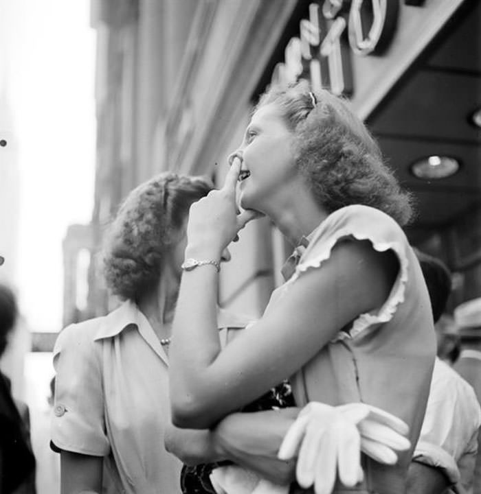 #41 A woman watching a model being painted for a billboard, 1947.