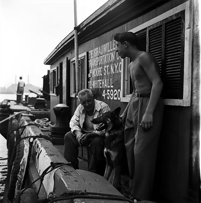 #46 Men with a German Shepherd on a dock, 1949.