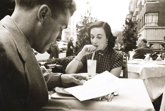 #48 At an outdoor cafe with a woman, 1948.