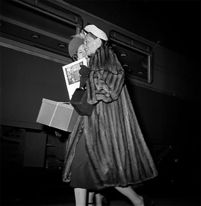 #68 Women walking near the train, 1948.