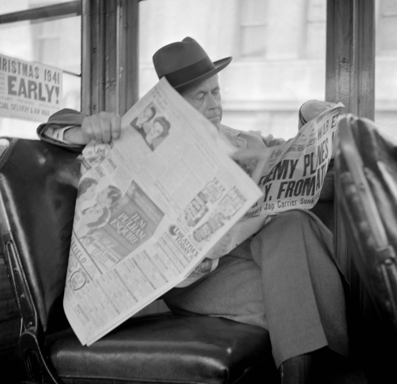 #17 Man reading a newspaper on a bus, San Francisco, California, USA, 1941.