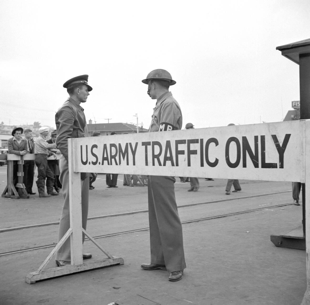 #21 Army sentries standing guard at a transport dock, San Francisco, California, USA, 1941.