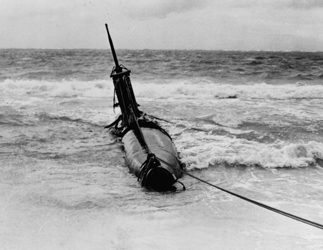 #27 A Japanese Type A midget submarine beached in eastern Oahu after it grounded following attempts to enter Pearl Harbor during the December 7, 1941 Japanese attack, 1941.