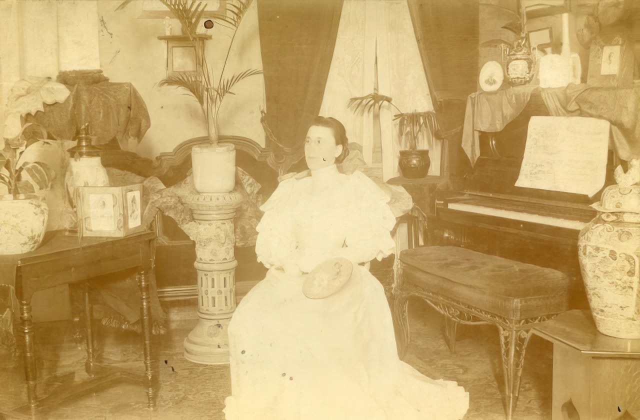 #23 Woman seated by piano