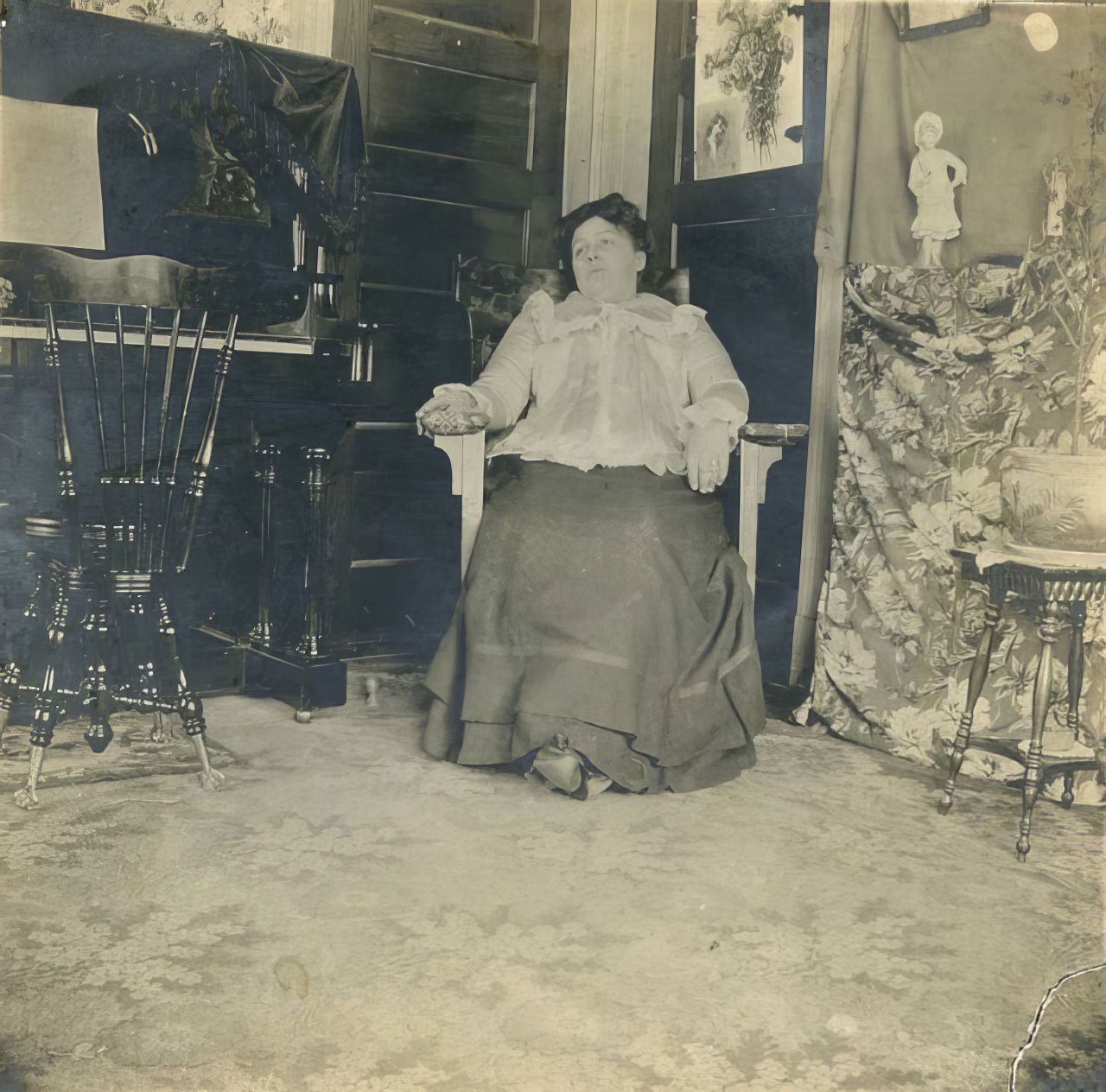 #24 Woman seated in corner of room