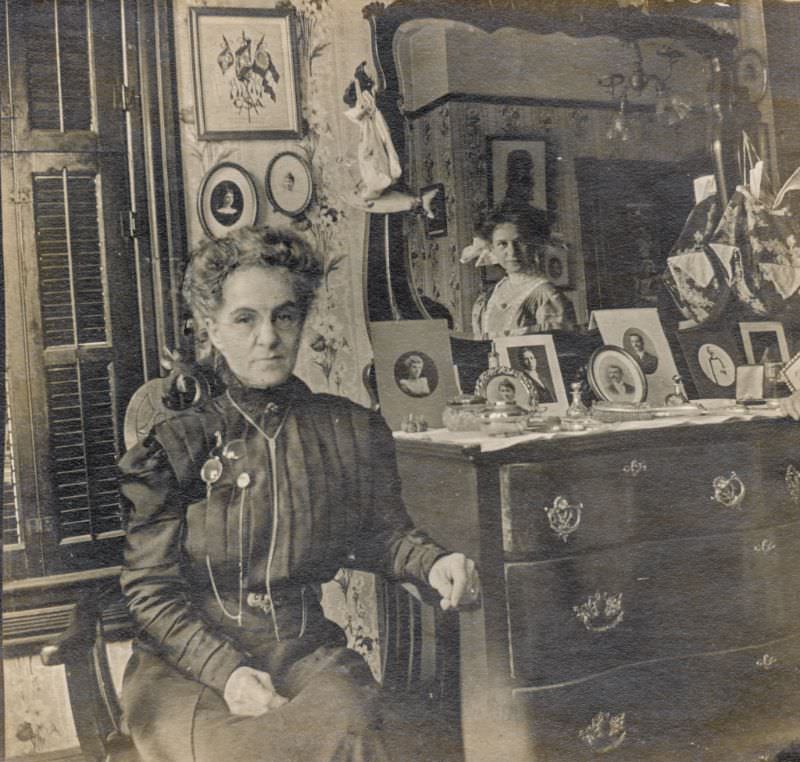 #27 Woman sits next to a mirror with another watching on