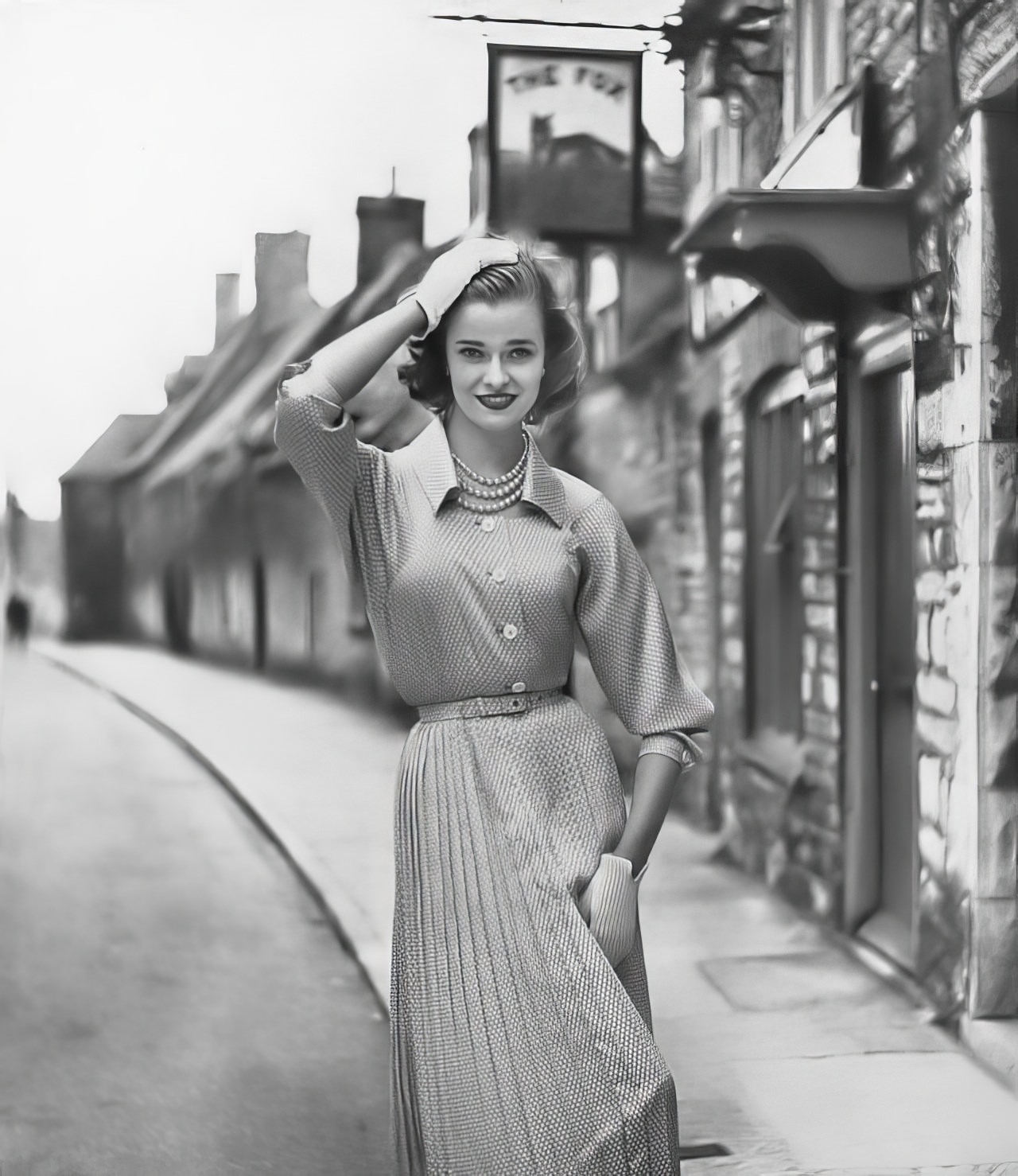 #12 Susan Abraham in a pale gray tie-silk dress ringed with white, 1952.