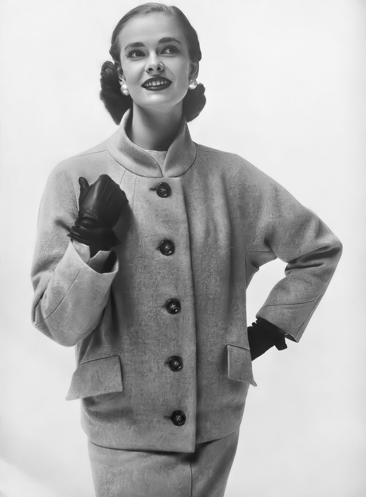 #18 Susan Abraham in a smoke-gray jacket with a stand-away collar, 1953.