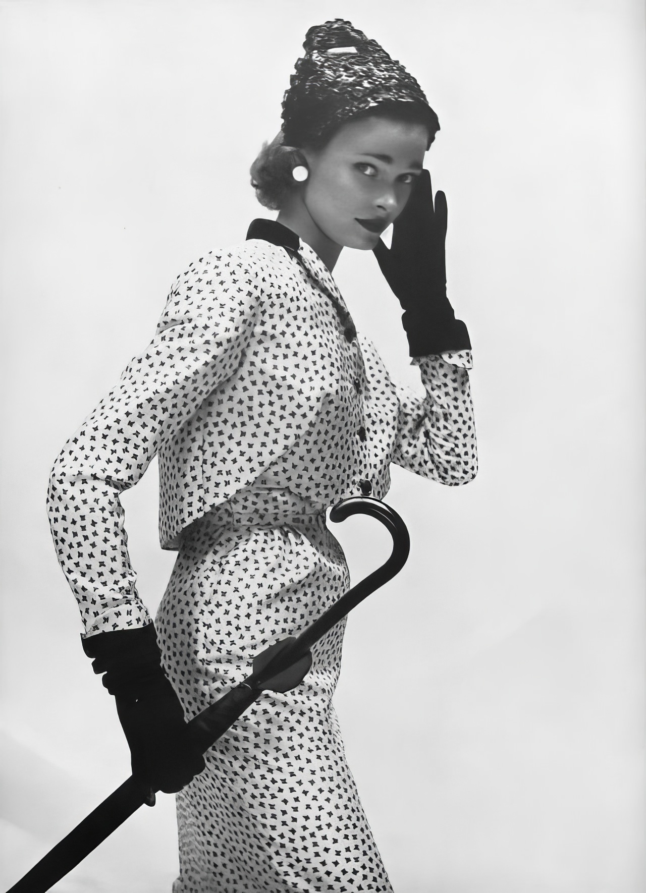 #21 Susan Abraham in a dress and jacket suit in white surah, 1953.