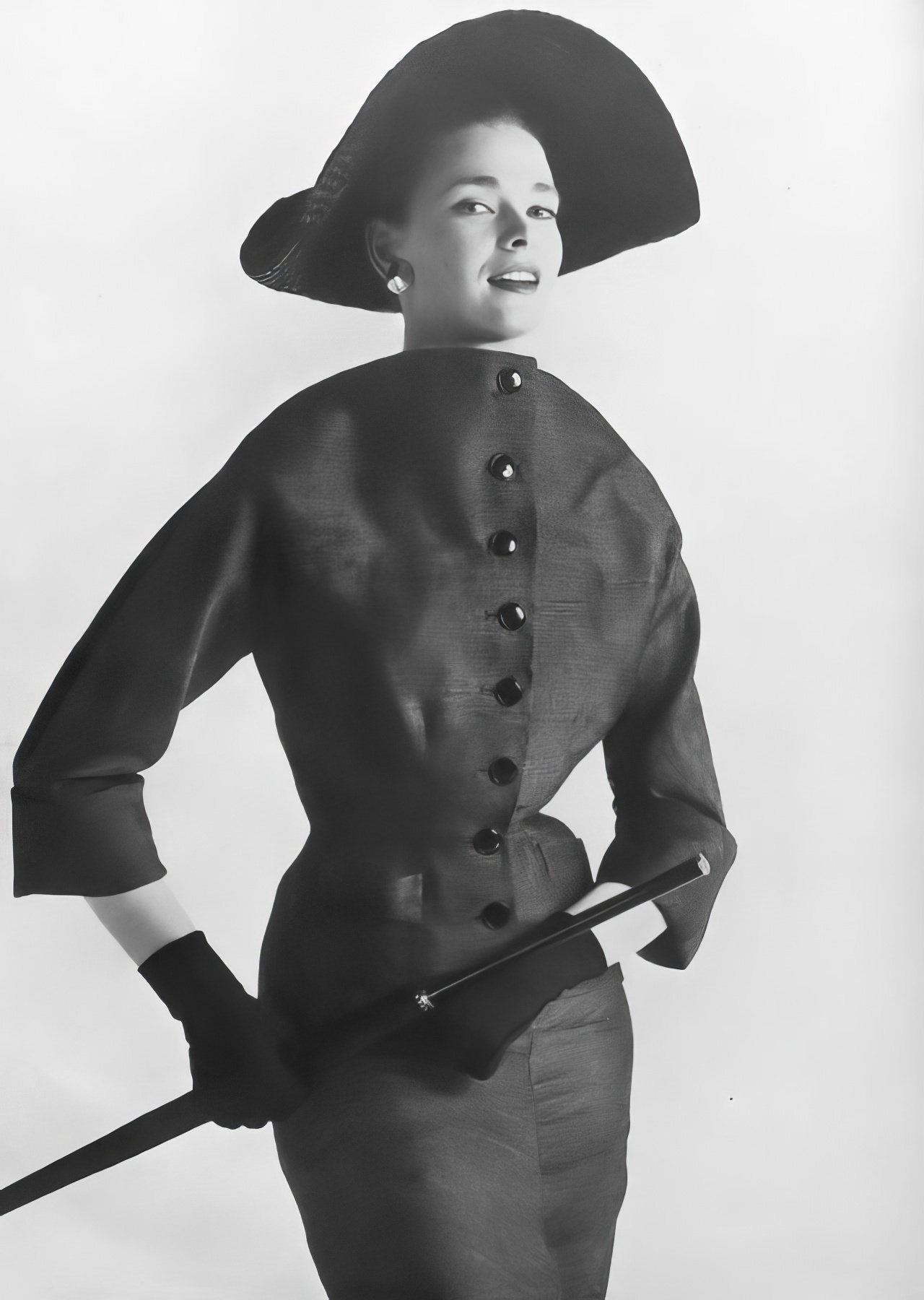 #23 Susan Abraham in a grayish-olive green suit, 1953.
