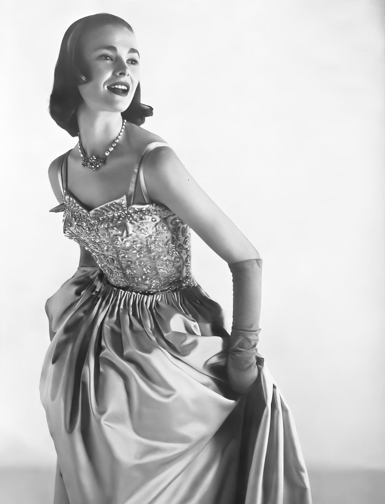 #28 Susan Abraham in a shining ball dress of lavender satin, 1953.