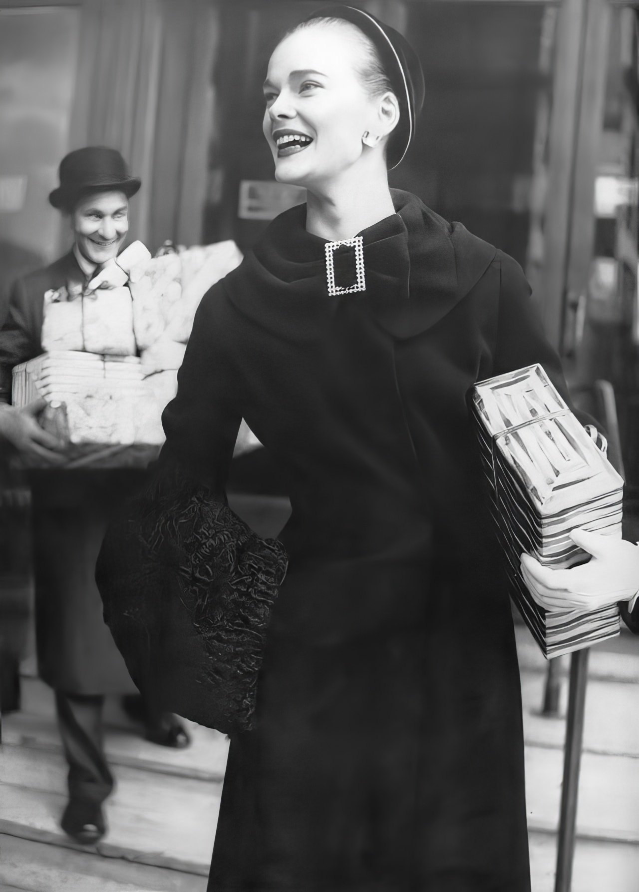 #31 Susan Abraham in a fitted coat of black worsted duvetyne, 1954.