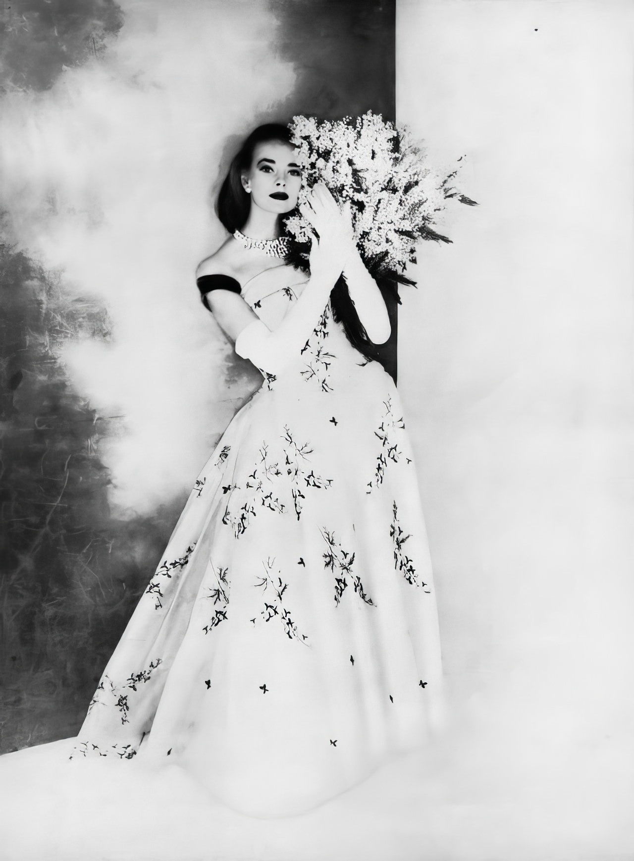 #33 Susan Abraham in a beautiful ball gown of bluebells embroidered on white silk organdie, 1956.