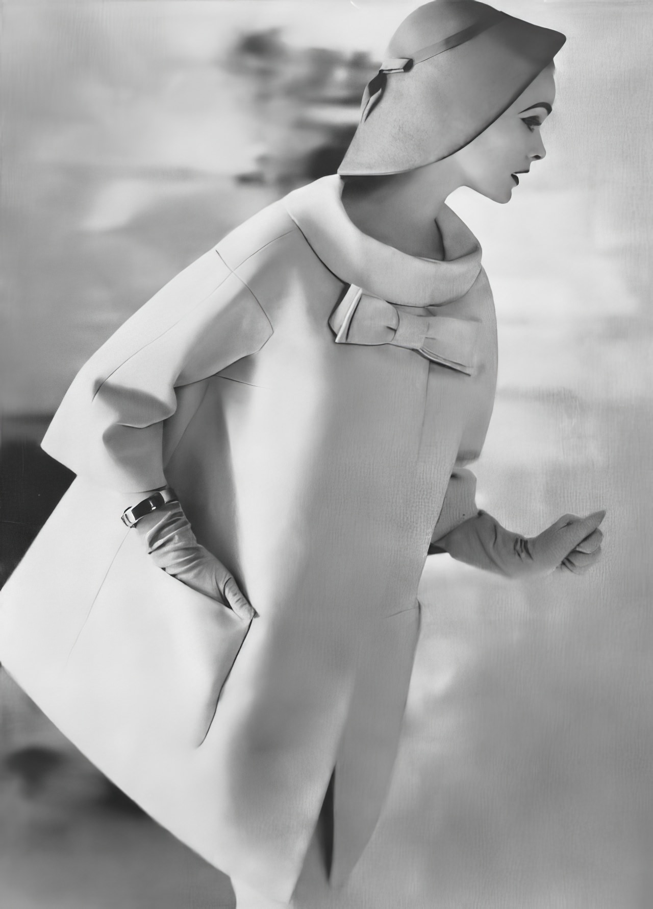 #36 Susan Abraham in a champagne-colored coat in linen hopsack, 1957.