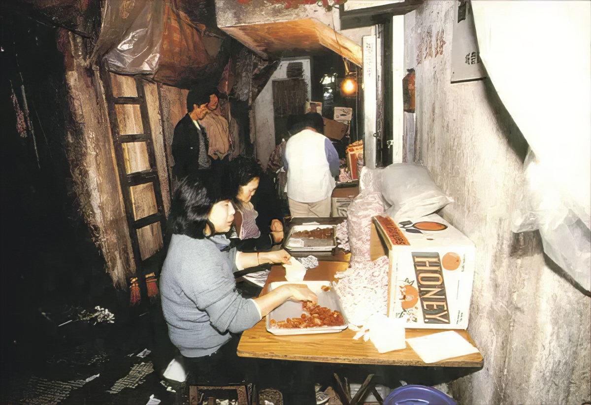 #12 Women making food in Kowloon Walled City. The city was known for its food production, as well as its plastics and textile manufacturing.