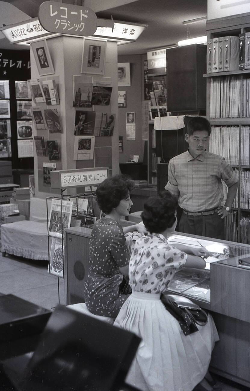 #18 Two young Japanese women in a record store in Tokyo, 1959.