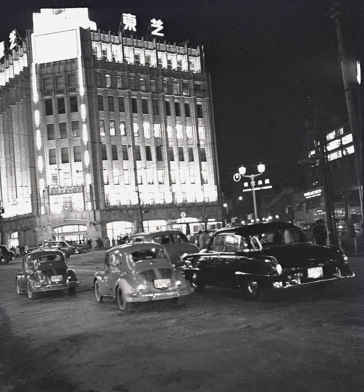 #48 Evening time in Tokyo, lit up buildings and motorcars, 1950s.