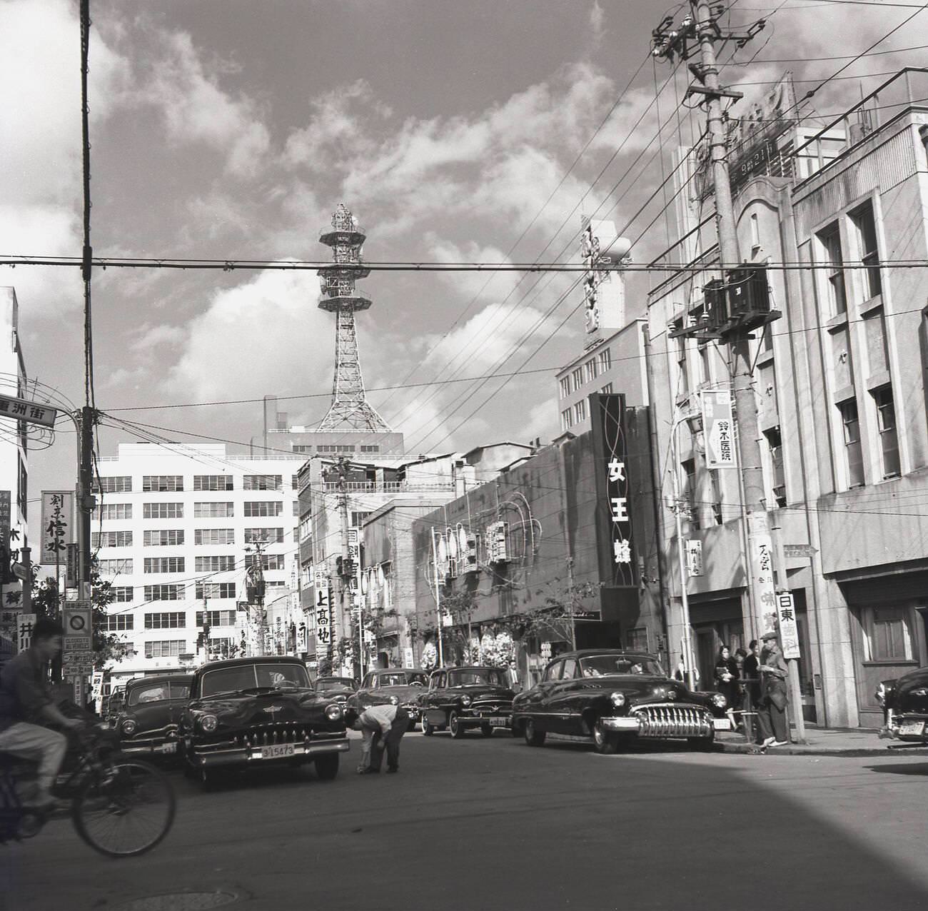 #85 A street in Tokyo with parked cars, 1950s.
