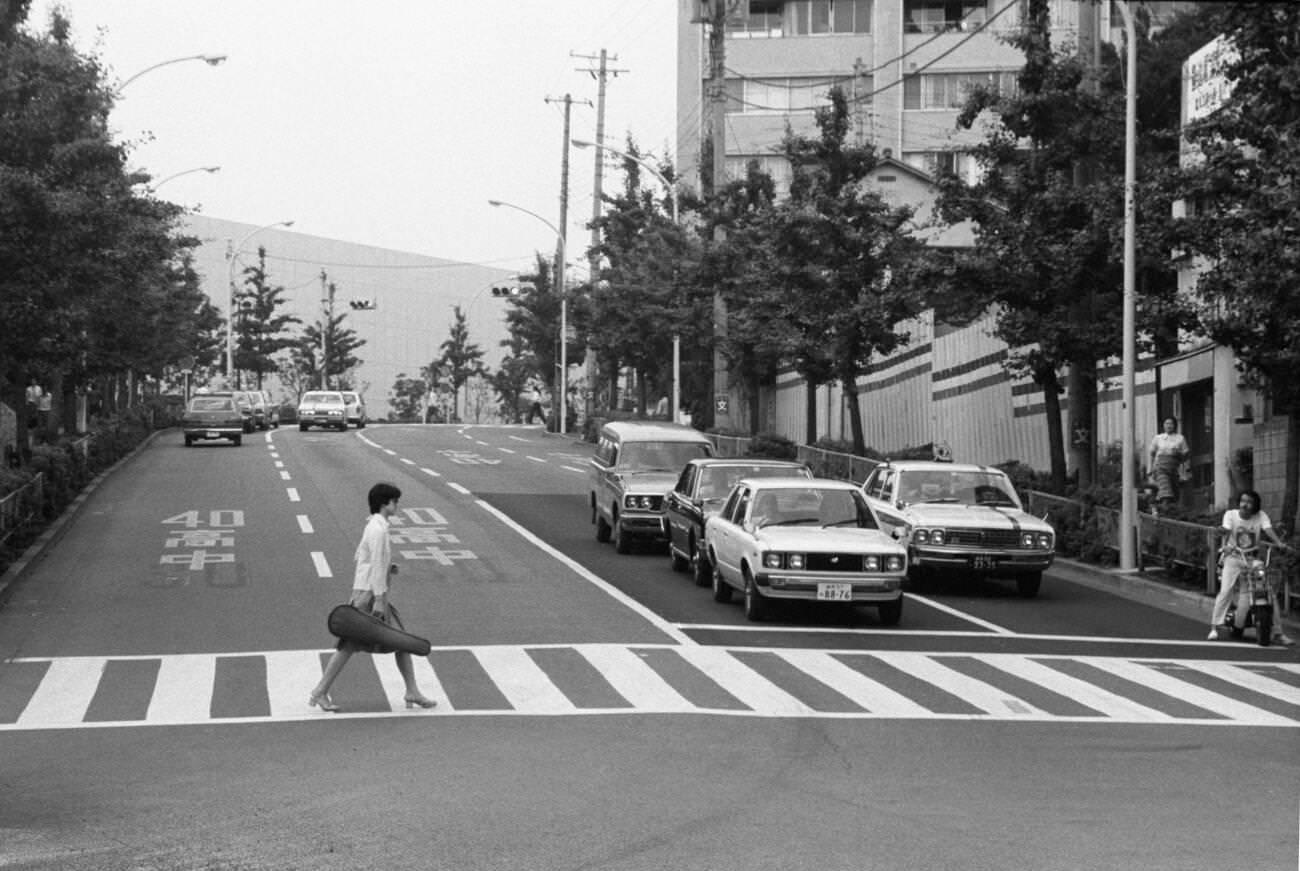 #61 A woman crosses the street, Tokyo, 1979.