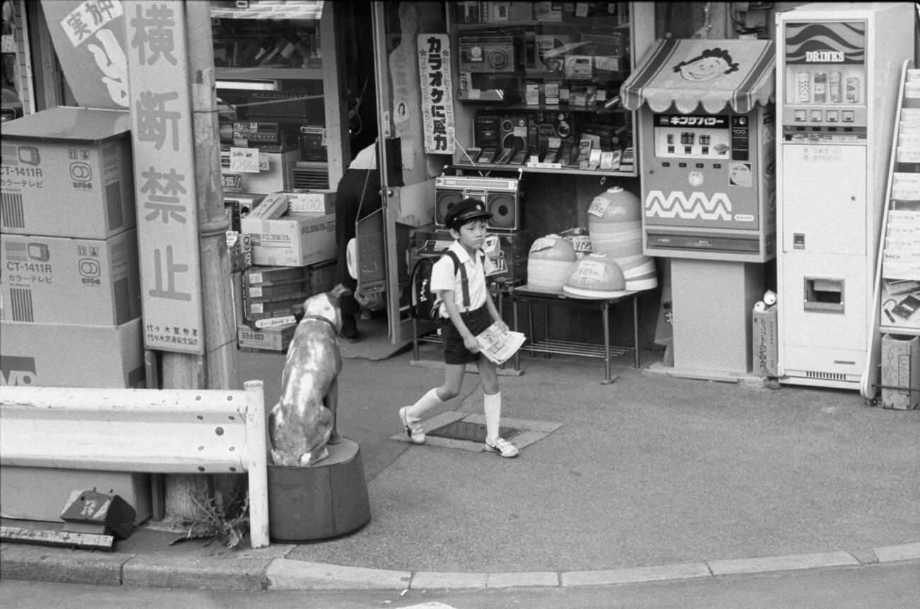 #127 A child with a newspaper in his hand, Tokyo, 1979.