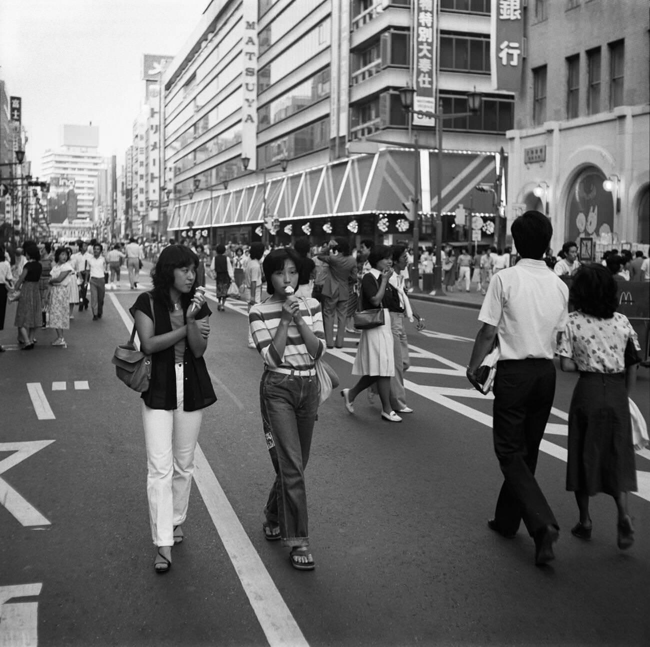 #71 Young women with ice cream walk down the street, Tokyo, 1978.