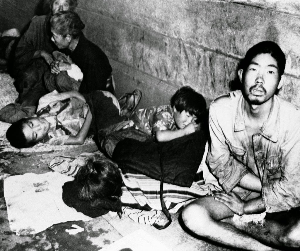 #52 Hundreds of Japanese jam the Ueno railway station in Northeast Tokyo, 1945.