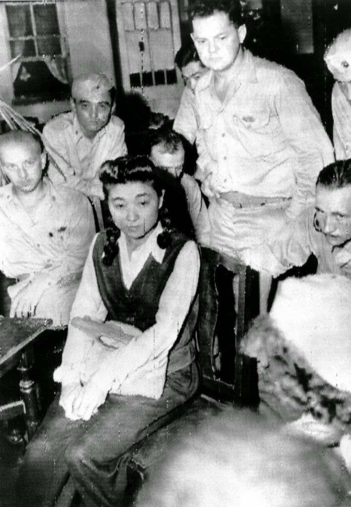 #54 Iva Toguri D’Aquino is interviewed by American journalists in Yokohama, Japan shortly before she is held in detention. She is known as Tokyo Rose, a radio personality whose program “Zero Hour” broadcast Japanese propaganda to the Allied troops during World War II, 1945.