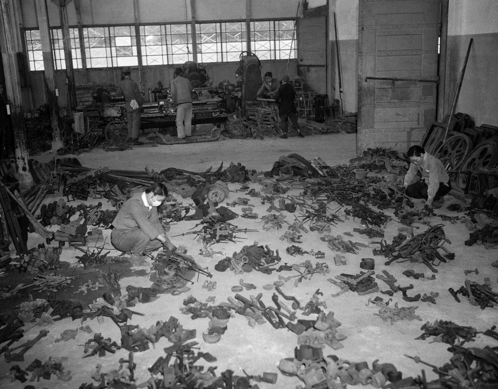 #59 Machine tools and parts for machinery are being made with metal melted down from scrap salvaged from the wreckage of former war plants. Girl employees check salvaged material at a warehouse in Tokyo, 1946.