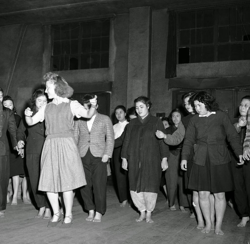 #67 Barbara McBride teaches Russian-style Korobotchka dance to her Japanese students at the YWCA in Tokyo, 1946.