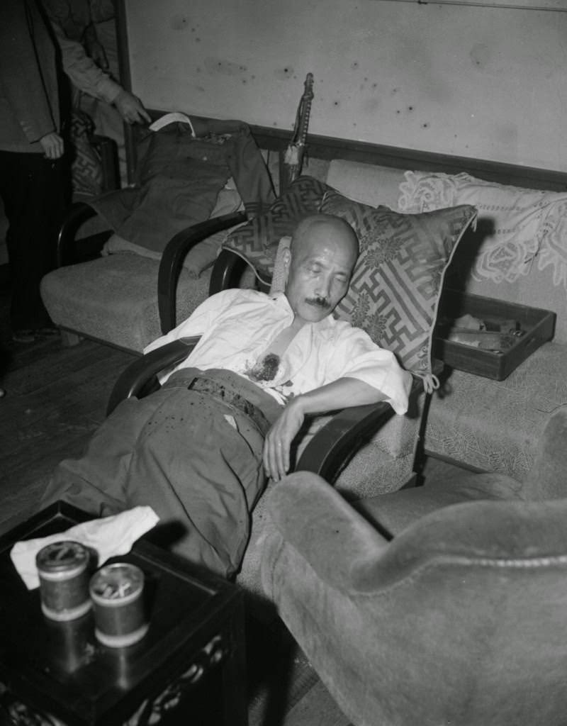 #70 Gen. Hideki Tojo, former Japanese premier, lies semi-conscious in a chair after he shot himself, 1945.