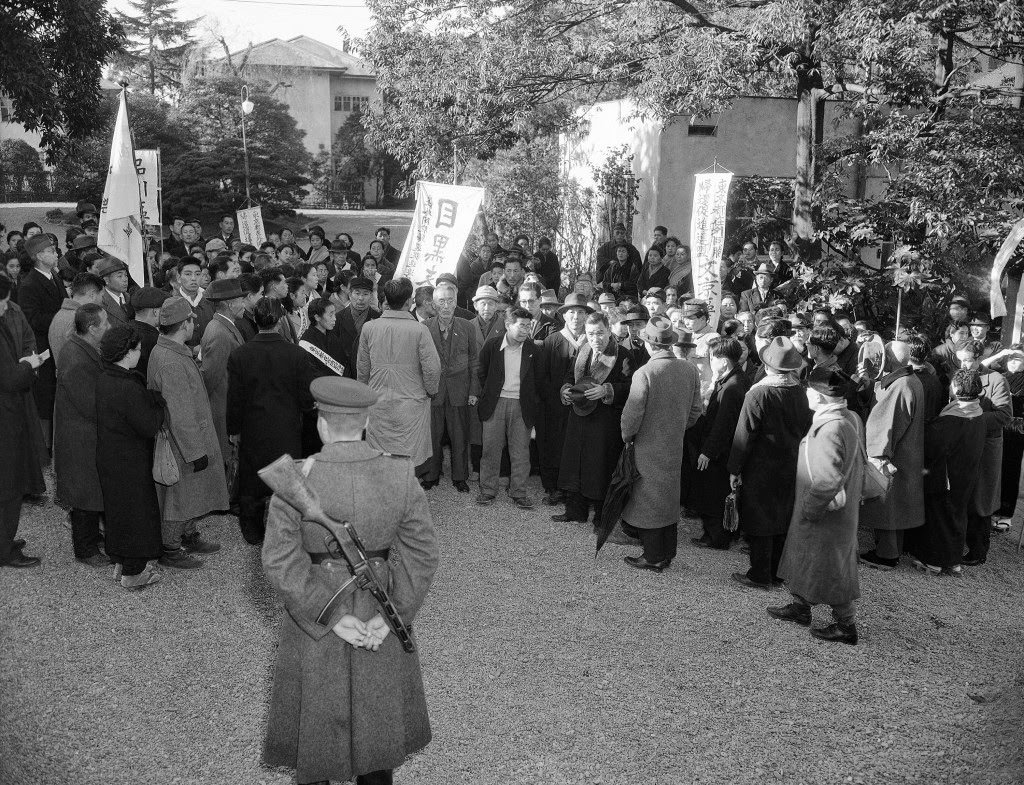 #72 Russian soldier with tommy gun stands guard outside the Russian Embassy as the members of the “Repatriation Association of Japan” await an answer to present their case to this head of the mission in person, in Tokyo, 1949.