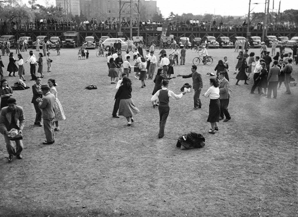 #75 The Virginia reel, a favorite American folk dance, is something new for the Japanese, dancing in Hibiya Park, Tokyo, 1949.