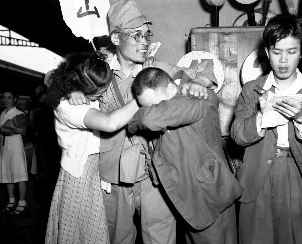 #79 Family members greet each other as a small group of the first batch of repatriates from Russian held territory who arrived back in Japan aboard the Takasago Maru arrived at Shinagawa station a few miles from Tokyo, 1949.