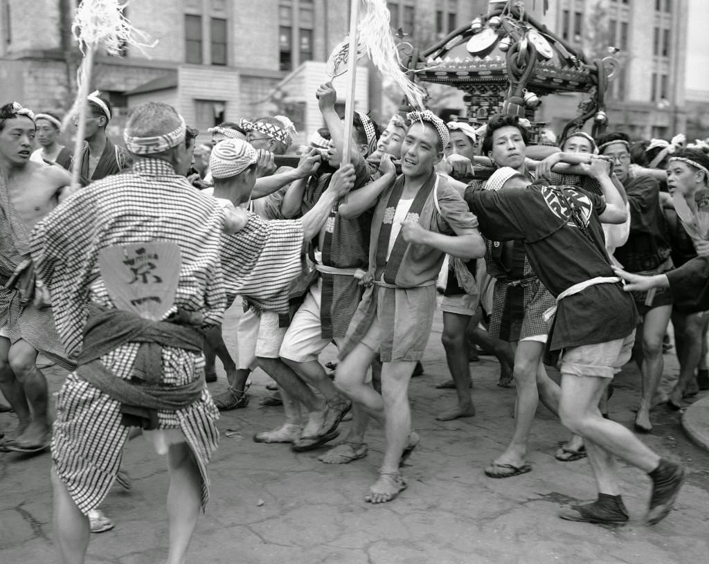 #80 These excited young men are taking part in a festival in the Konda district of the city of Tokyo, 1949.