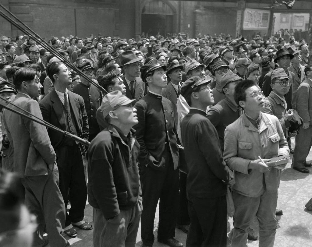 #98 Tokyo citizens turn out to watch the bulletin boards announcing the election results for the candidates for the diet in front of the Asahi Newspaper office in Tokyo, 1947.