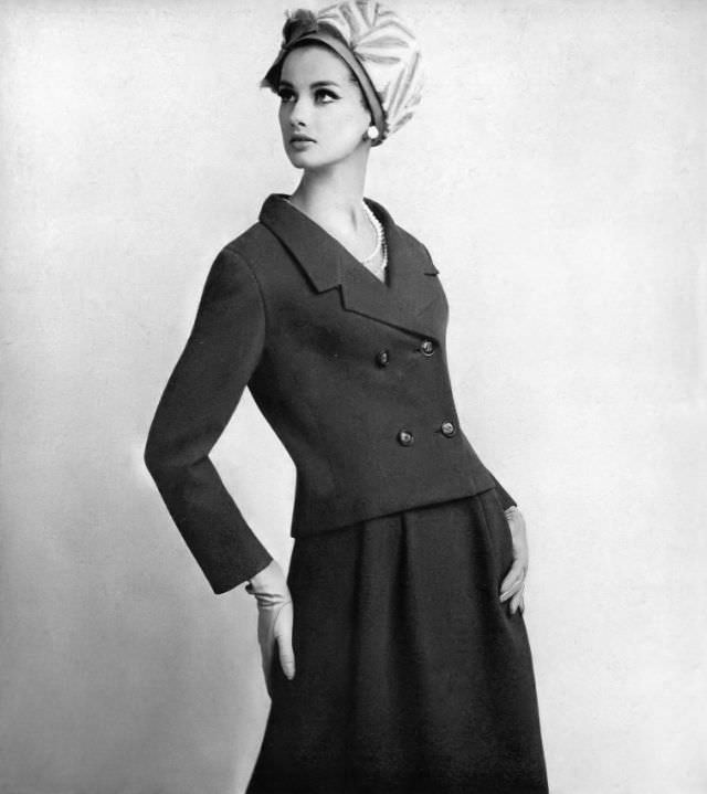#24 Veronica Hamel in a curved jacket and fluid skirt, 1965.