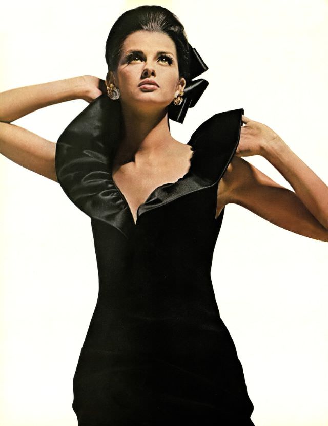 #2 Veronica Hamel in a black crepe cocktail dress with the Queen Anne collar, 1964.